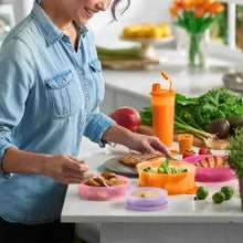 Meal prep containers on a kitchen table; person filling colorful containers with food