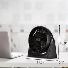 Compact desk fan with black base and circular grille in a 3/4 view