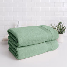 Green Turkish towel set with two bath towels folded together, ribbed trim bands