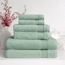 Green Turkish towel set with four folded towels stacked, ribbed trim bands