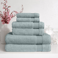 Light blue Turkish towel set with four folded towels stacked, ribbed trim bands