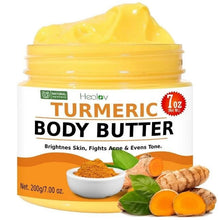 Yellow turmeric body butter jar with open lid and whipped cream, with turmeric root pieces