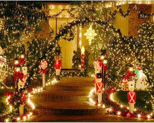 Warm white Christmas string lights garland around nutcracker decorations near steps