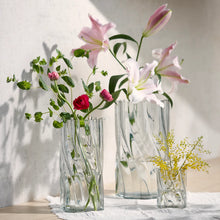Set of two twisted glass vases with faceted fluted sides, clear with pale tint.