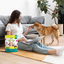 Freeze-dried beef liver treats pouch next to a dog during feeding