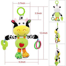 Cow plush hanging toy size view with green ring and colorful teether loops
