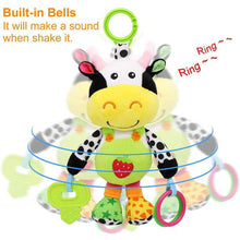 Cow plush rattle toy with bell sounds, green ring and looped teether attachments