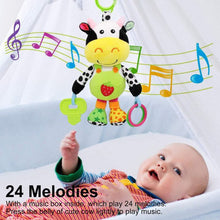 Cow plush hanging rattle with green ring and dangling colorful teether charms