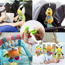 Cow plush hanging toy with green ring and colorful teether pieces for stroller