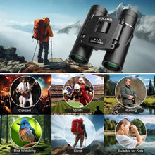 Black compact binoculars with strap and eyepieces, placed outdoors near a hiking backpacker.