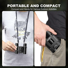 USCAMEL compact binoculars in hand, portable fold design with strap attachment.