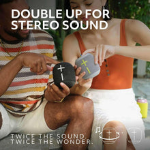 Two compact wireless Bluetooth speakers held for stereo sound, cross icons visible