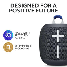 Black wireless Bluetooth speaker with blue handle and cross icon; circular eco badges