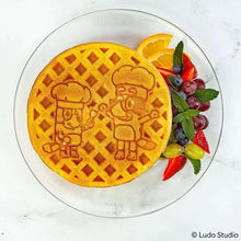 Golden brown character waffle with Bluey outline design on a plate