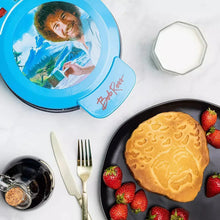 Blue Bob Ross waffle maker with open round lid and portrait window