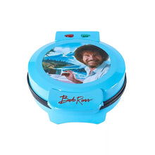 Blue Bob Ross waffle maker with round lid, portrait window, and front logo