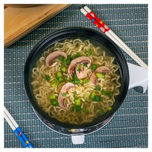 Ramen noodles in Mickey Mouse hot pot with mushrooms and green onions