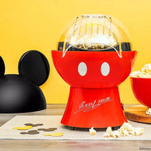 Red Mickey popcorn maker with open clear lid and popping chamber above tray