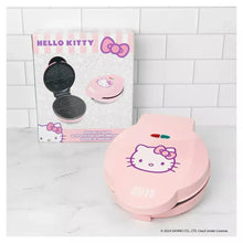 Pink Hello Kitty quesadilla maker with open cooking plates, top view