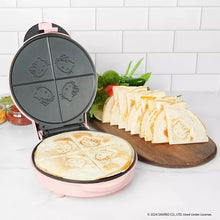 Pink electric quesadilla maker with round plates open and Hello Kitty designs