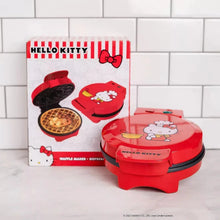 Red Hello Kitty waffle maker beside product box and instruction graphic