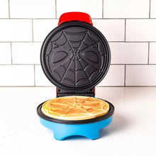 Waffle maker with open circular spider-web plate and red handle