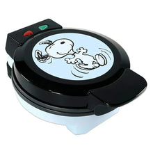 Black Snoopy waffle maker with open latch and circular character design on lid