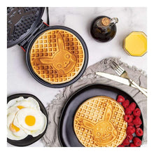 Pikachu waffle maker open with round plates showing character-shaped waffles