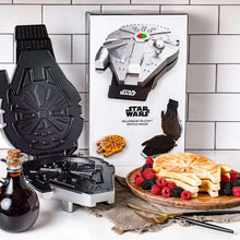Open Falcon waffle maker with black mold, plus Falcon-shaped waffles and fruit