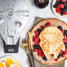 Falcon-shaped waffle with berries on board beside Falcon waffle maker plate