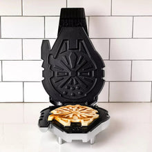 Black and metallic Falcon waffle maker open with browning waffle