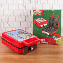 Red waffle maker with lid art and retail box on tabletop