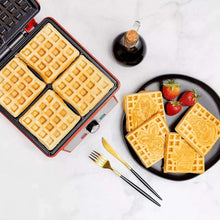 Open waffle maker with square grid plates and four waffles on a dish