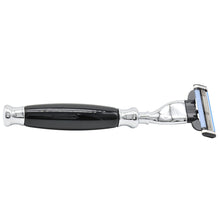 Black and silver safety razor with cartridge head, side view