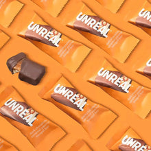 Dark chocolate caramel peanut nougat bar wraps arranged in rows