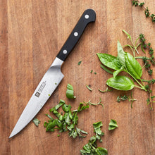 6-inch utility knife with silver blade and black handle, placed on its side