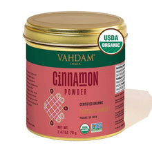 Ground cinnamon powder jar with red label, green band, and USDA Organic seal.
