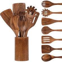 Assorted wooden cooking utensils in tall cup holder, including ladle and slotted spatulas.