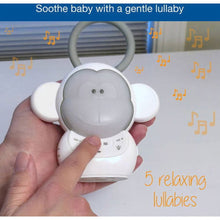 Baby monkey sleep soother with hand pressing the front button area