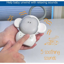 Baby monkey sleep soother held in hand with side ears and buttons