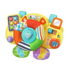 Baby driver toy close-up with yellow console, rainbow plush ring, and glowing red corners