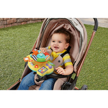 Baby driver toy in stroller with child holding the orange and yellow console