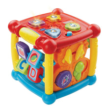 Colorful plastic activity cube toy with red top and chunky side buttons