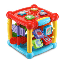 Colorful plastic activity cube toy with blue base and window-like shape blocks