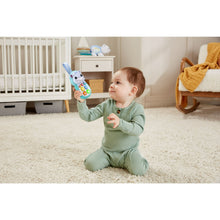 Baby reaching for the plush hippo soft phone toy on the floor