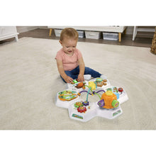 Baby activity table on floor with colorful animal buttons and interactive play panels