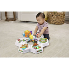 Baby activity table featuring an arch spinner, piano keys, and various colorful toy pieces