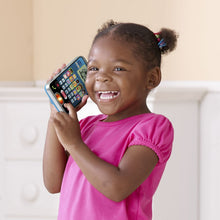 Young girl holding VTech learning phone toy up in front, blue keypad screen
