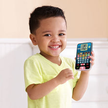Child smiling while holding VTech learning phone toy with blue display and buttons