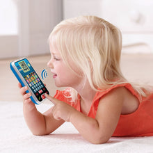 Toddler lying down holding VTech learning phone toy with blue screen and keypad